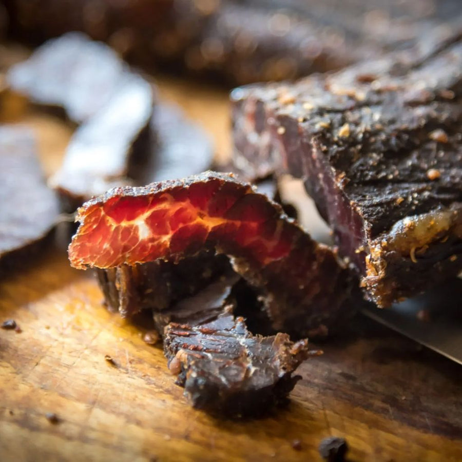 Sliced biltong on a wooden board